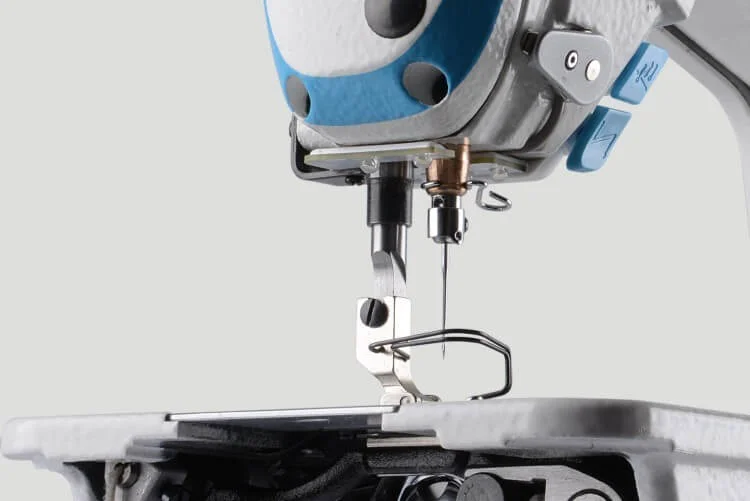 Dixie Tailoring Supply Close-up view of the needle area on the JACK A2S Automatic Industrial Single Needle Sewing Machine, highlighting the needle, presser foot, and nearby mechanical components. Tailoring Supplies