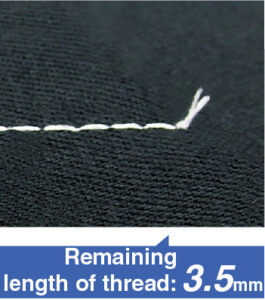 Dixie Tailoring Supply Close-up of white thread stitched on black fabric with a frayed end, highlighting precise work by the JUKI DDL-8000 Lockstitch Machine with Automatic Thread Trimmer; text reads "Remaining length of thread: 3.5 mm". Tailoring Supplies