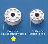 Dixie Tailoring Supply Two metal bobbins for the JAPANFUJI DU 1181 walking foot sewing machine on a blue surface—the left is for double-capacity hook, the right for standard hook. Tailoring Supplies