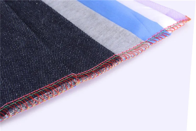 Dixie Tailoring Supply Close-up of fabric edges with multicolored layers, overlocked using red, green, and orange thread on the Jack E4 Industrial Overlock/Serger Sewing Machine. Tailoring Supplies