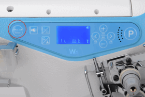 Dixie Tailoring Supply Close-up of the Jack W4 UT01 Automatic Flat Bed Coverstitch Industrial Sewing Machine's blue control panel, featuring various buttons, a digital display, and a reset button circled in red on the left side. Tailoring Supplies