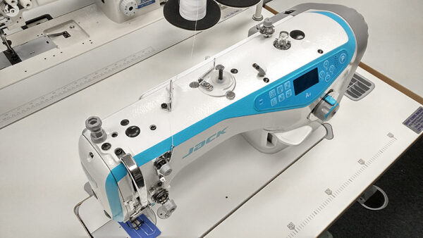 Dixie Tailoring Supply In a cozy tailoring store, the JACK A4 Fully Automatic Industrial Sewing Machine, with its sleek white and blue design, digital display, and multiple dials, stands ready—perfect for crafting exquisite tailored products. Tailoring Supplies