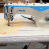 Dixie Tailoring Supply In a bustling tailoring store, the JACK A2S Automatic Industrial Single Needle Sewing Machine sits prominently on the table. With blue and white components, it navigates fabric and sketches, while a ruler on the table's edge ensures precision—a true testament to quality tailor products. Tailoring Supplies