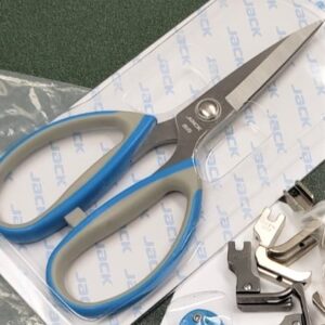 Dixie Tailoring Supply The JACK SCISSORS, featuring blue and gray handles, rest on their packaging amidst metallic sewing machine parts—ideal for any tailoring store's collection. Tailoring Supplies