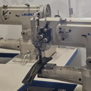 Dixie Tailoring Supply Two JUKI LS 1341 Industrial Walking Foot Cylinder Arm Sewing Machines are set side by side in a workspace, with a yellow thread spool visible in the background. Tailoring Supplies