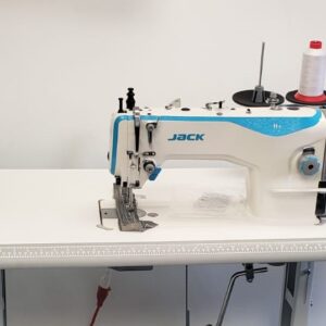 Dixie Tailoring Supply In the tailoring store sits a JACK H2 Industrial Walking Foot Sewing Machine, featuring a stylish white and blue design. A spool of red and white thread is attached, ready for stitch-perfect creations. Tailoring Supplies