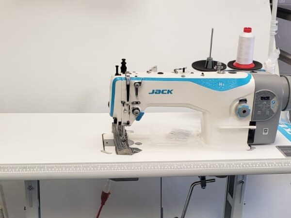 Dixie Tailoring Supply In the tailoring store sits a JACK H2 Industrial Walking Foot Sewing Machine, featuring a stylish white and blue design. A spool of red and white thread is attached, ready for stitch-perfect creations. Tailoring Supplies