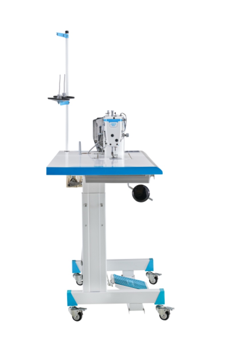 Dixie Tailoring Supply Side view of an industrial sewing machine with a blue and white table, thread stand, foot pedal, and wheels for mobility. Tailoring Supplies
